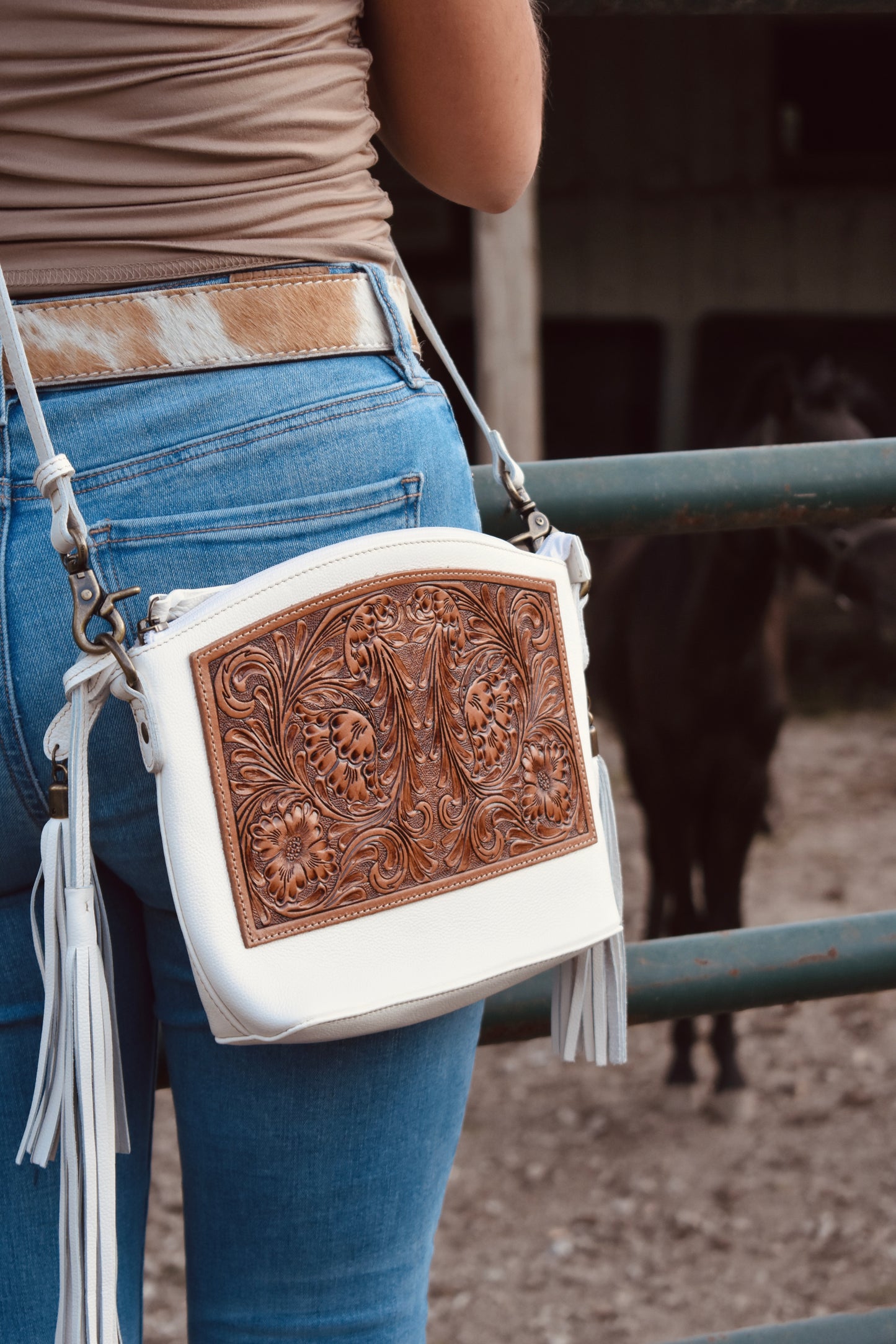 White hand-tooled crossbody